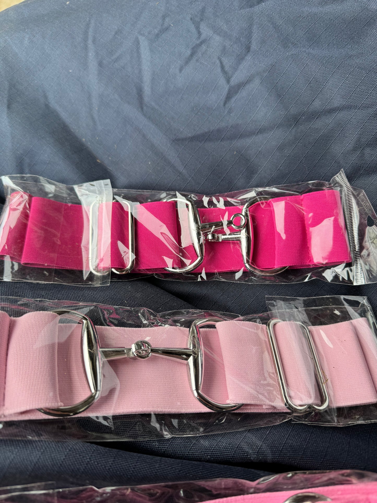 Surcingle belts with snaffle bit style hook fastenings