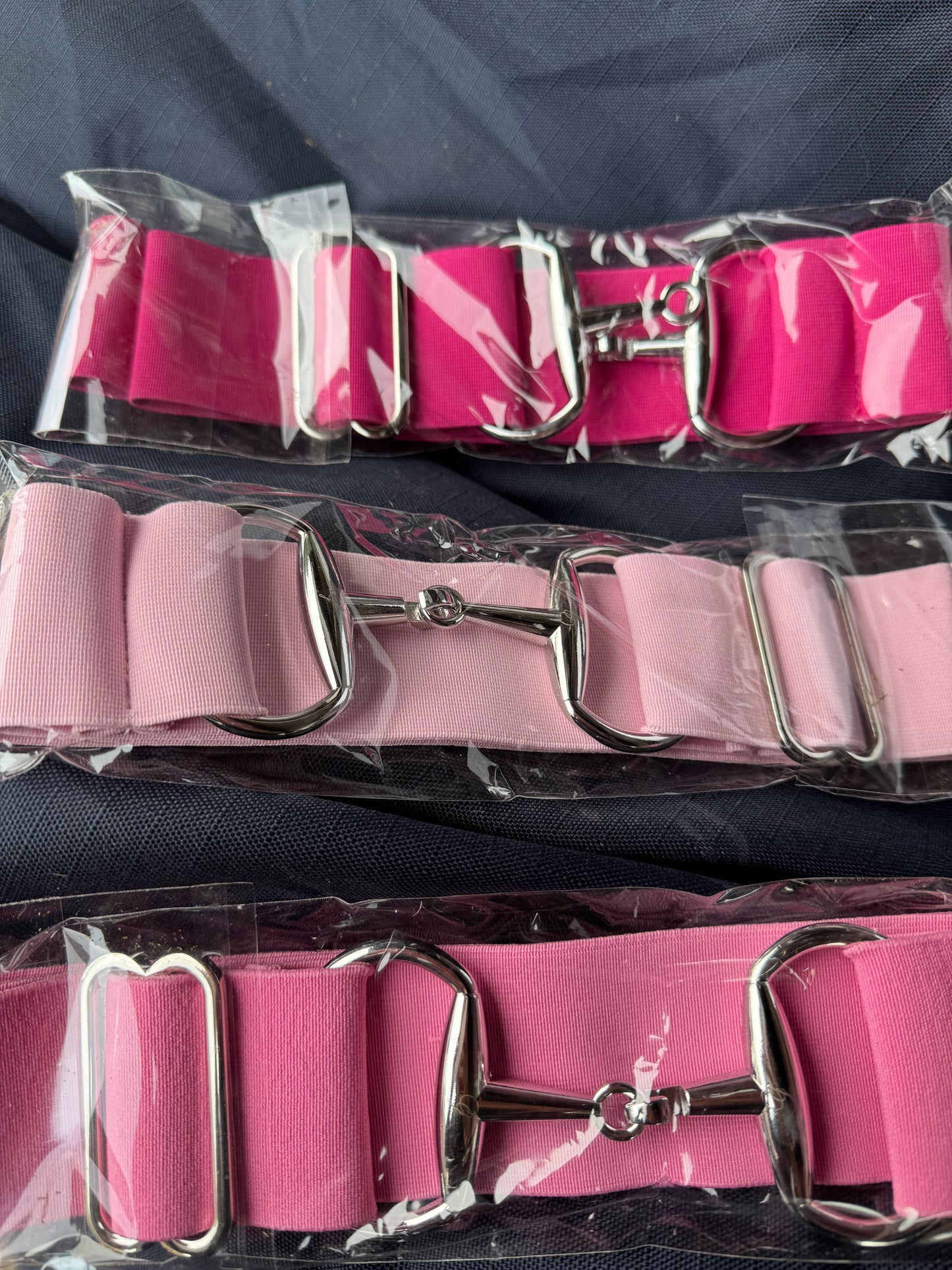Surcingle belts with snaffle bit style hook fastenings